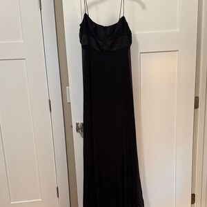 Elegant black flowy maxi dress with beaded embellishments on the top.
